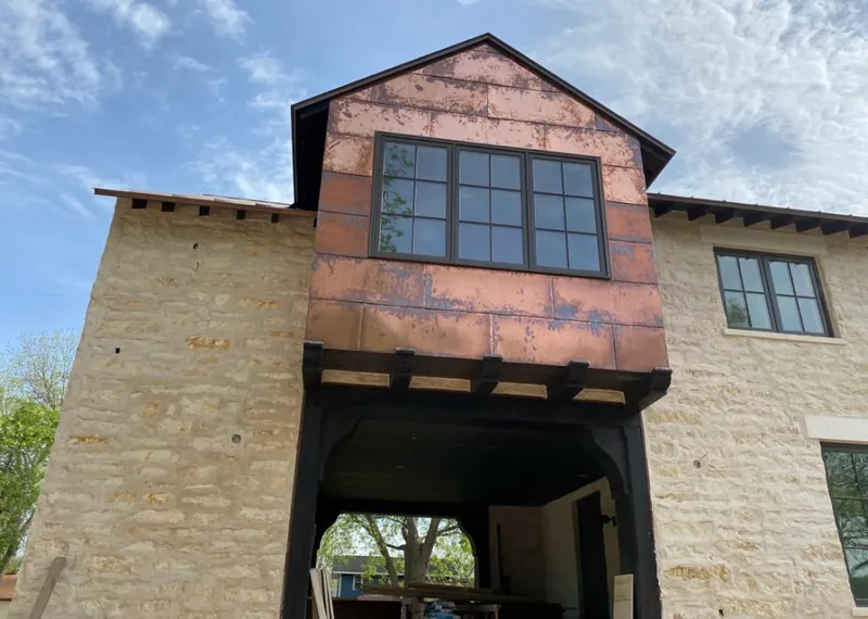Copper metal panel facade on a stone building for Skylight Installation in Orangetree